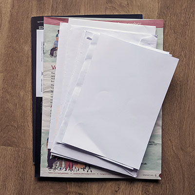 Photograph of junk mail, newspaper and magazine.